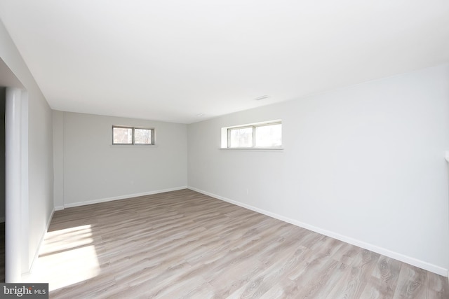 basement with light hardwood / wood-style flooring