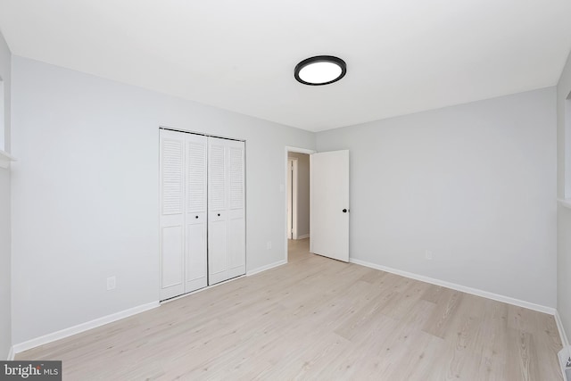 unfurnished bedroom with light hardwood / wood-style floors and a closet