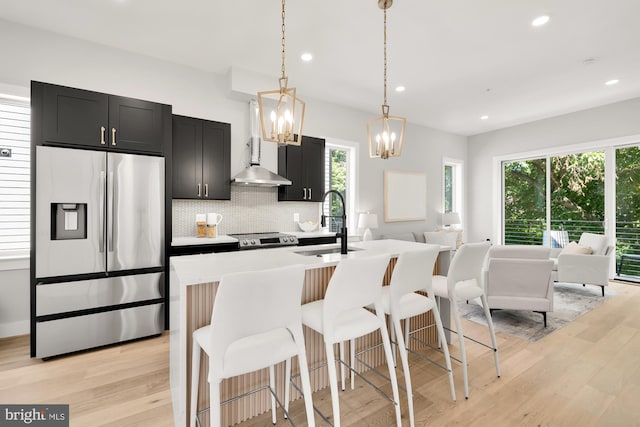 kitchen featuring hanging light fixtures, appliances with stainless steel finishes, a wealth of natural light, and sink