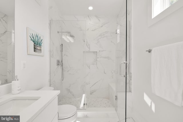 bathroom featuring vanity, toilet, and a shower with door