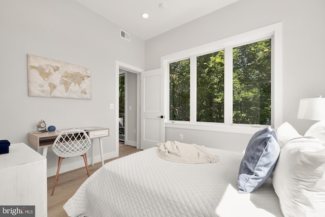 bedroom featuring light hardwood / wood-style floors and multiple windows