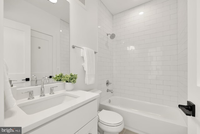 full bathroom with tiled shower / bath combo, toilet, and vanity