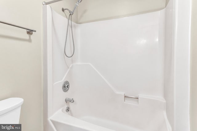 bathroom featuring toilet and washtub / shower combination