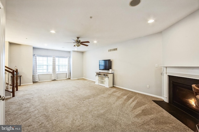 unfurnished living room with carpet floors and ceiling fan