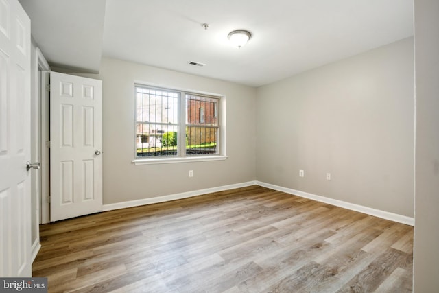 unfurnished room with light hardwood / wood-style flooring