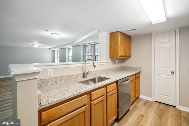 kitchen with kitchen peninsula, light stone countertops, sink, light hardwood / wood-style flooring, and dishwasher