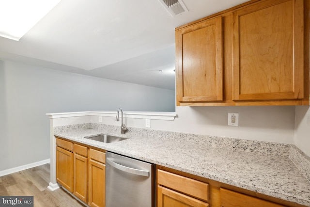 kitchen featuring dishwasher, light hardwood / wood-style floors, light stone countertops, and sink