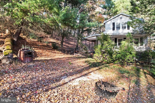 view of yard with an outdoor fire pit