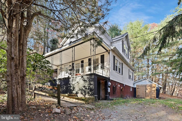 exterior space featuring a shed and a balcony