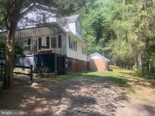 view of property exterior featuring a storage unit