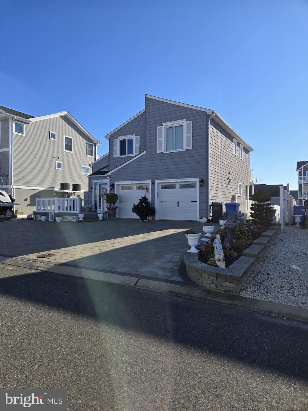 47 Henry Dr, Manahawkin, NJ 08050 - view of front facade featuring a garage, a deck, and central air condition unit
