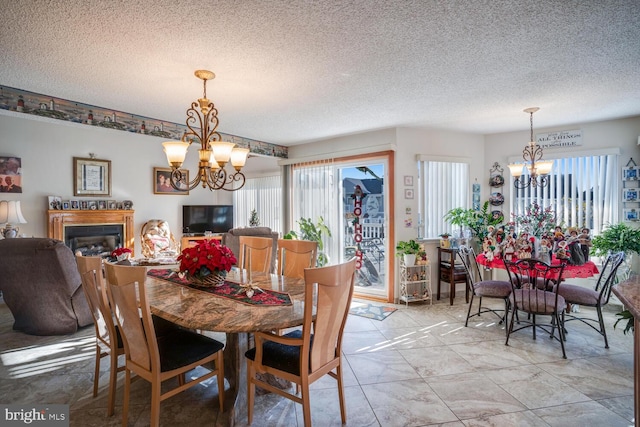 dining area featuring a textured ceiling and an inviting chandelier