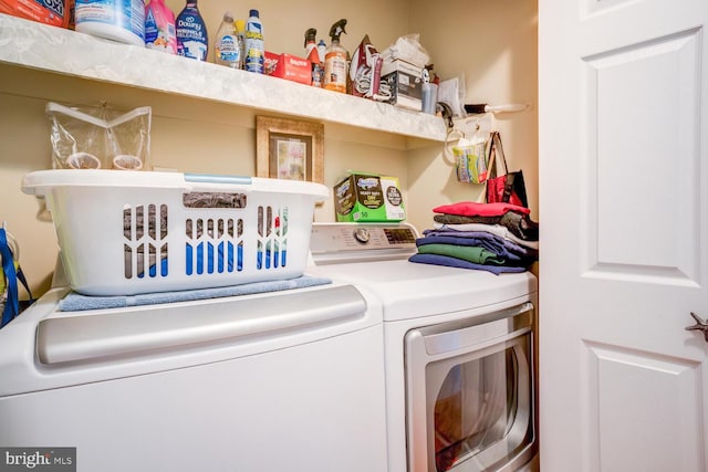 laundry area with separate washer and dryer