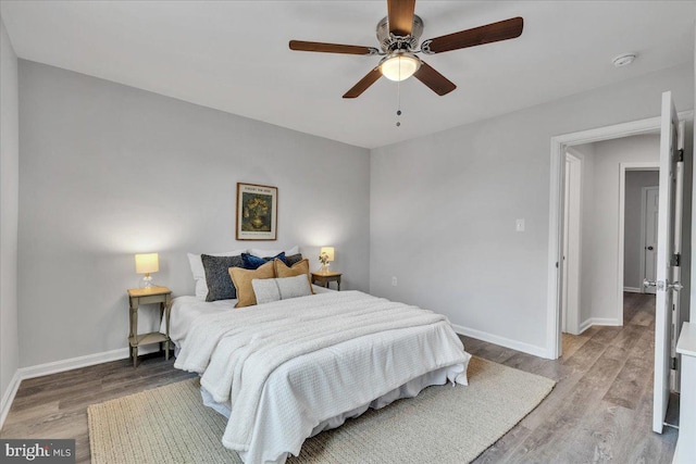 bedroom with ceiling fan and hardwood / wood-style flooring