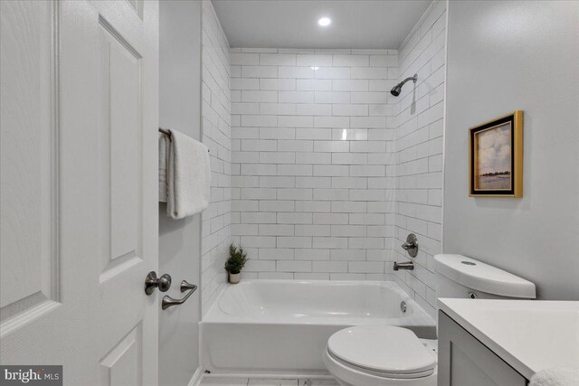 full bathroom featuring vanity, toilet, and tiled shower / bath