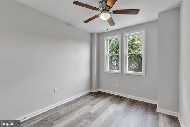 spare room with light hardwood / wood-style flooring and ceiling fan