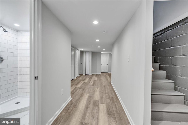 hallway with light hardwood / wood-style flooring