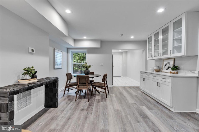 dining space with light hardwood / wood-style floors