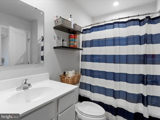 bathroom with a shower with curtain, vanity, and toilet