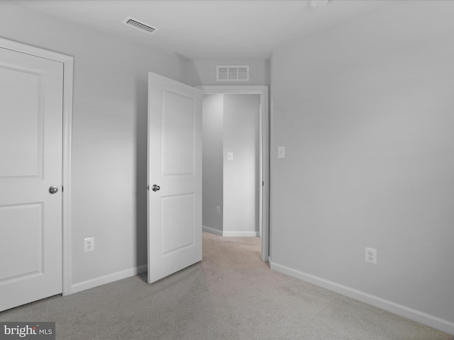 unfurnished bedroom with light carpet