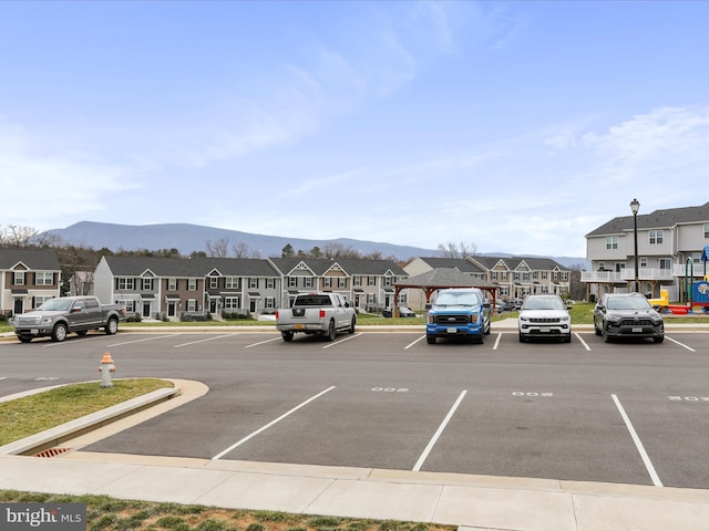 view of parking with a mountain view