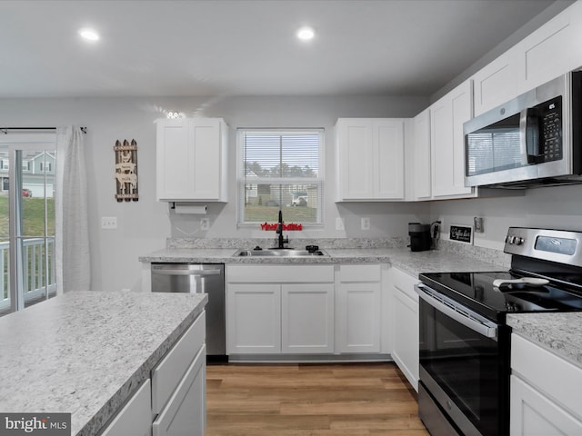 kitchen featuring sink, white cabinets, and stainless steel appliances