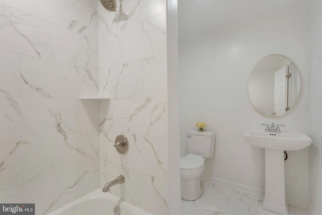 full bathroom featuring tiled shower / bath, sink, and toilet