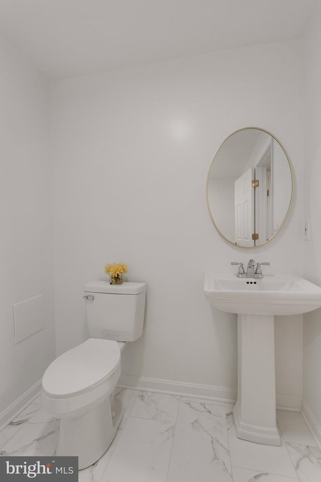 bathroom featuring sink and toilet