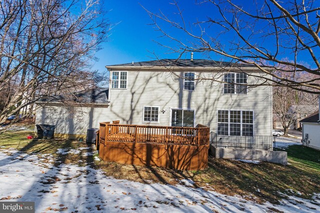 snow covered property with a wooden deck