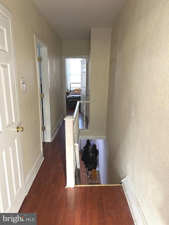 corridor featuring dark hardwood / wood-style floors