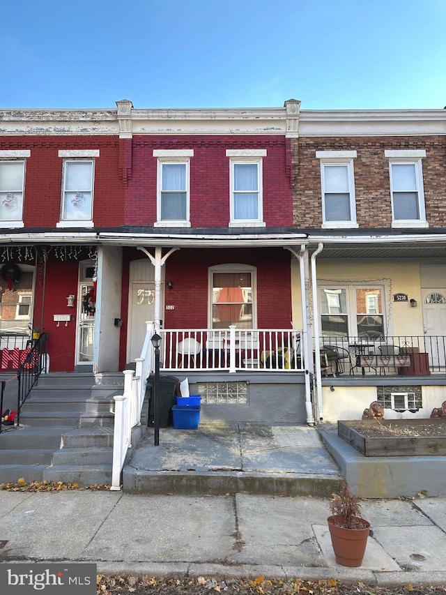 townhome / multi-family property featuring a porch