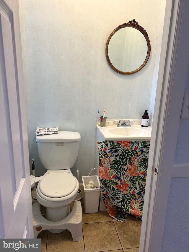 bathroom featuring toilet, vanity, and tile patterned floors