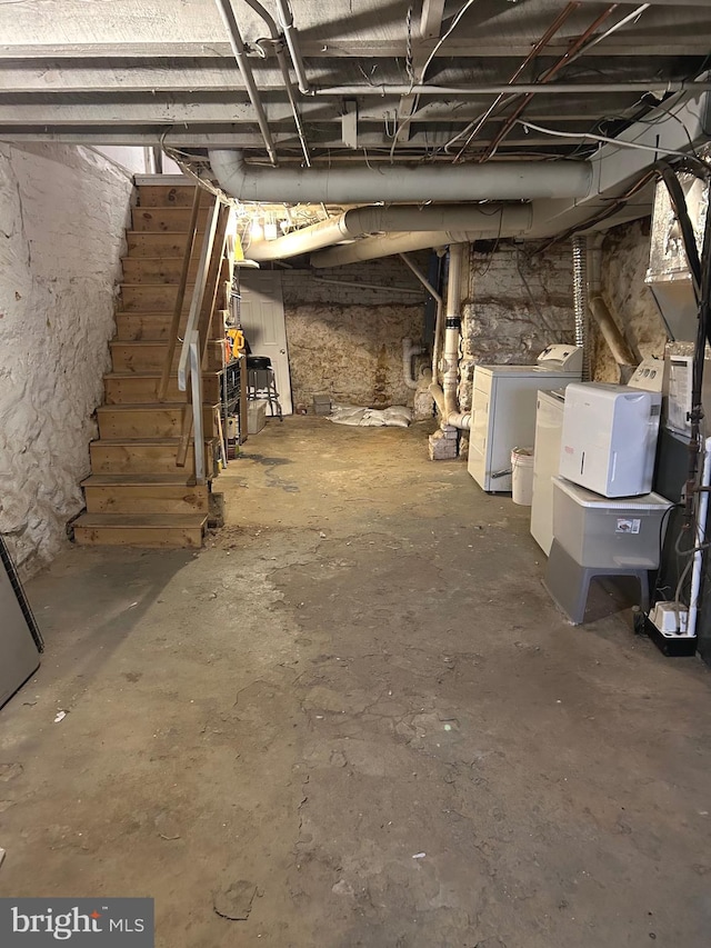 basement with washing machine and clothes dryer