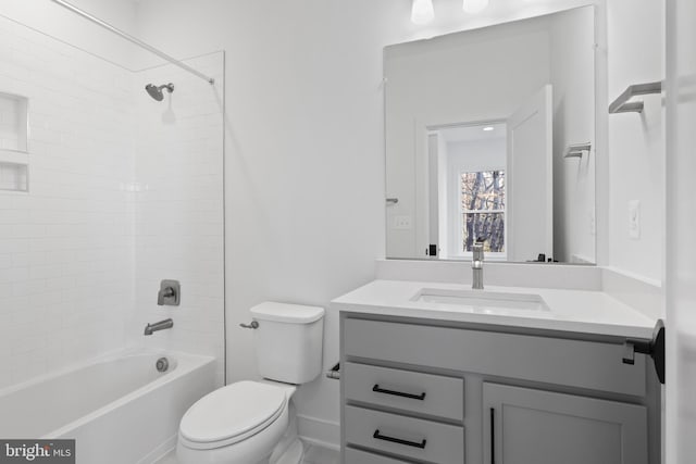 full bathroom featuring toilet, vanity, and tiled shower / bath