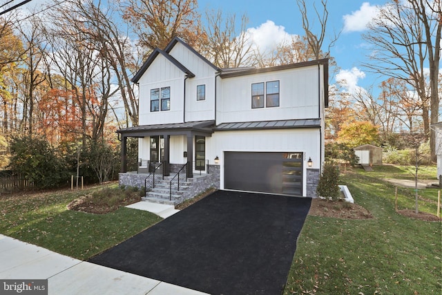 modern farmhouse featuring a porch, a garage, and a front yard