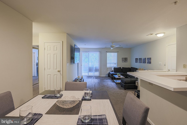 dining area with carpet flooring and ceiling fan