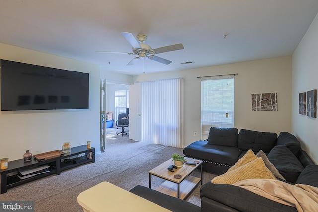 carpeted living room with plenty of natural light and ceiling fan