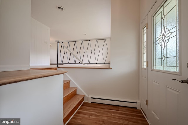 entryway with hardwood / wood-style floors and a baseboard radiator