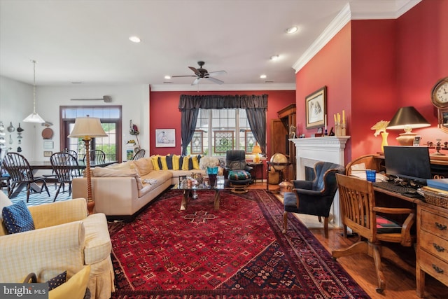 living room featuring ceiling fan, ornamental molding, and wood-type flooring