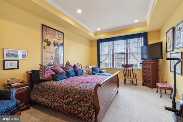 bedroom featuring crown molding, a raised ceiling, and light carpet