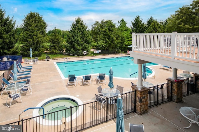 view of pool with a patio area and a hot tub