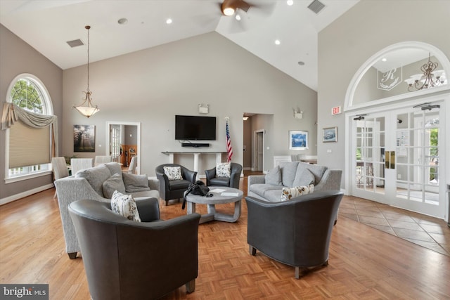 living room featuring high vaulted ceiling and french doors