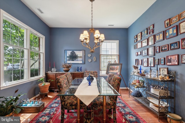 dining room featuring a notable chandelier and wood-type flooring