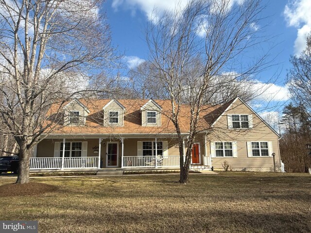 cape cod home featuring a porch and a front yard