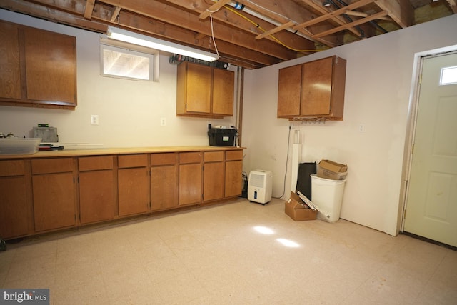37978 George F Dr, Mechanicsville, MD 20659 - kitchen featuring light countertops, light floors, brown cabinets, and a healthy amount of sunlight
