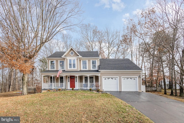 view of front facade with a porch, a garage, and a front lawn