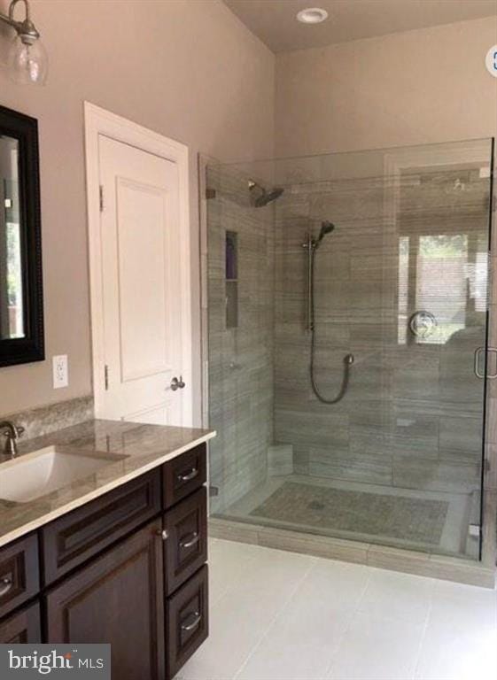 bathroom featuring vanity, tile patterned floors, an enclosed shower, and plenty of natural light