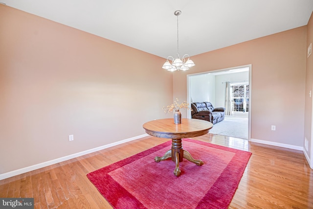 dining room featuring a chandelier and hardwood / wood-style flooring