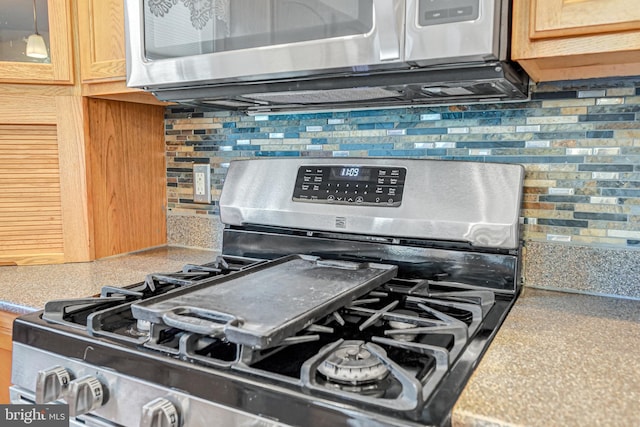 room details with tasteful backsplash, light brown cabinets, and stainless steel appliances