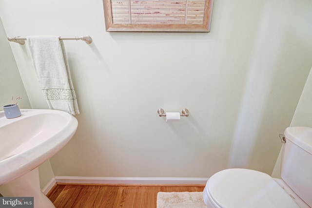 bathroom featuring hardwood / wood-style floors, toilet, and sink